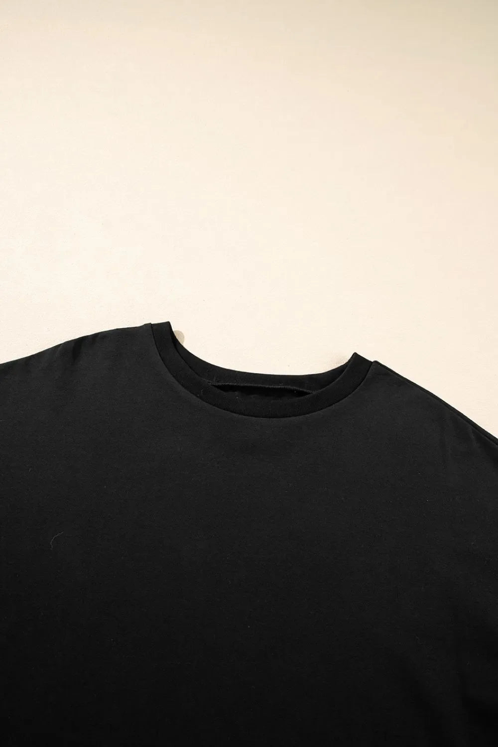 Camiseta holgada de media manga con dobladillo alto y bajo