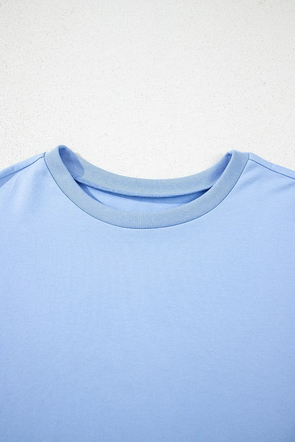 Camiseta holgada de media manga con dobladillo alto y bajo