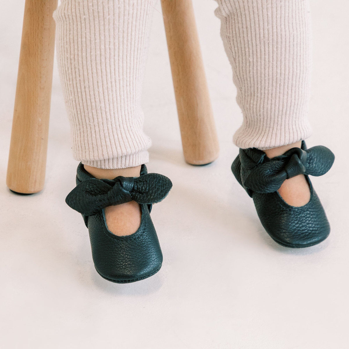 Zapato de bebé con lazo anudado de ébano