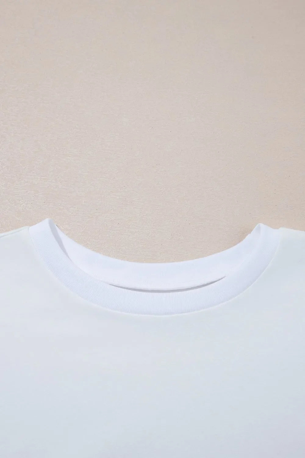 Camiseta holgada de media manga con dobladillo alto y bajo