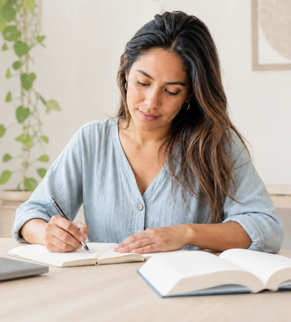 Community member studying with a notebook